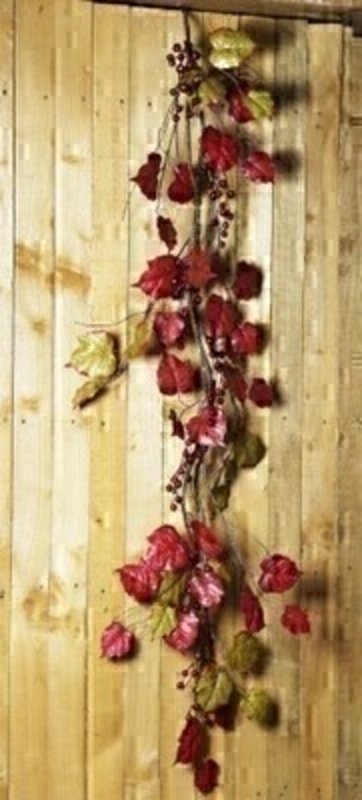 Garland of Red and Green Leaves and Berries by Bloomsberry Red and Green artificial garland made from mixed leaves and red berries by Bloomsbury. These stunning silks give the impression they have just been hand picked from a autumn forrest and would look lovely hanging on a door on wall for Autumn. For realistic artifical and silk flowers Bloomsbury is second to none. Matching artifical wreath also available.